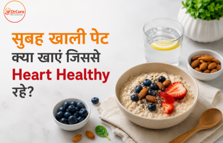 Heart healthy breakfast awareness poster showing oats bowl with strawberries, blueberries, almonds, lemon water, and healthy food items alongside Hindi text about what to eat on an empty stomach for better heart health, featuring DrCuro branding.